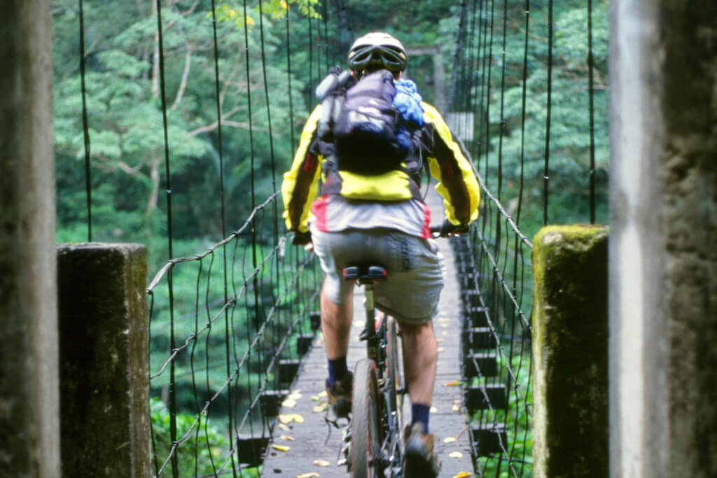 John McHale crossing a suspension bridge on the La La Shan trail