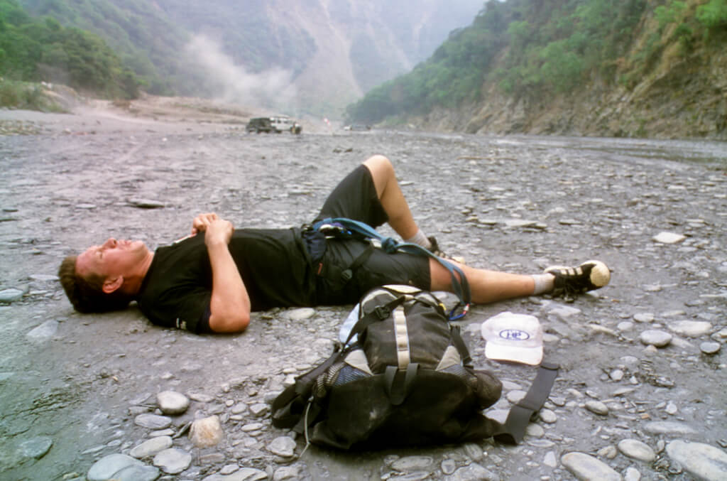 Patrick O'Leary taking a breather after an intense river crossing while covering an Action Asia adventure race